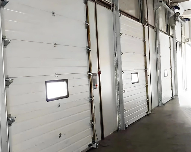 Electrically operated sectional overhead door